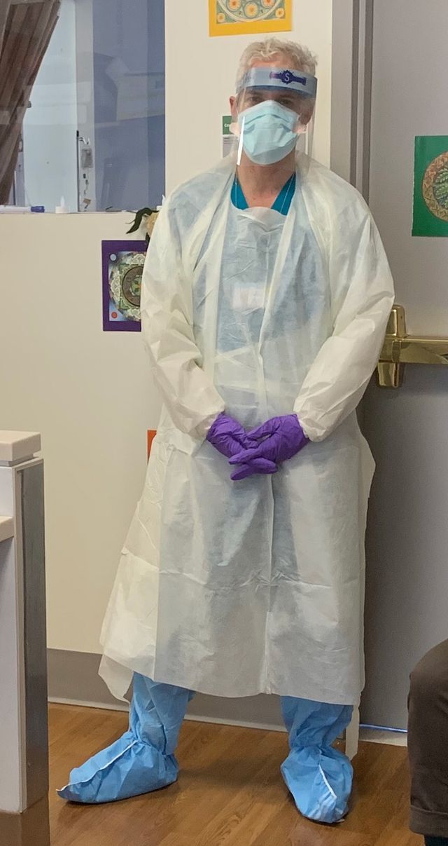 A vertical picture of Dr. Craig Blinderman, who is wearing full personal protective equipment of a gown and mask